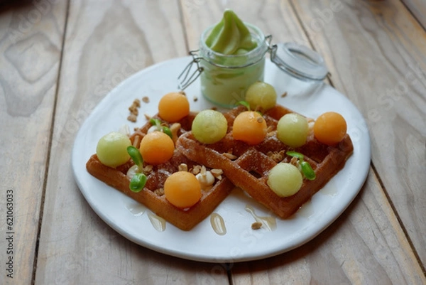Fototapeta Waffle and melon set with avocado cream.