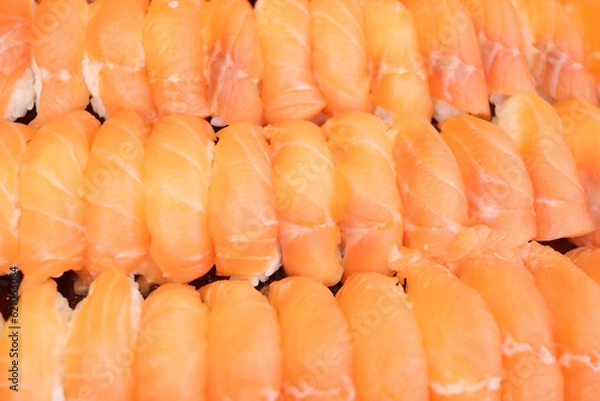 Fototapeta Salmon and shrimp sushi arranged in a row.