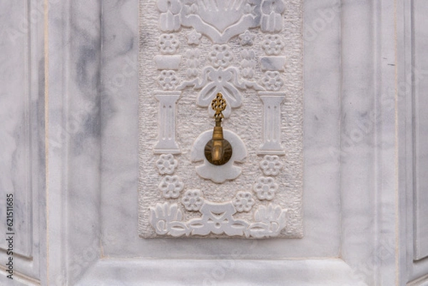 Fototapeta patterned marble floor in the background of the old bronze faucet