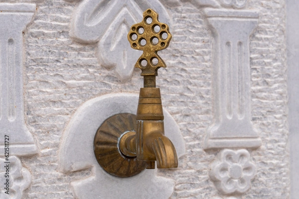 Fototapeta patterned marble floor in the background of the old bronze faucet