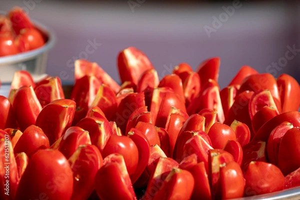 Fototapeta salted tomatoes sliced ​​for drying close-up