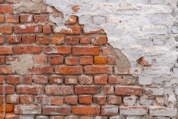 Fototapeta old red brick wall with plaster, close up