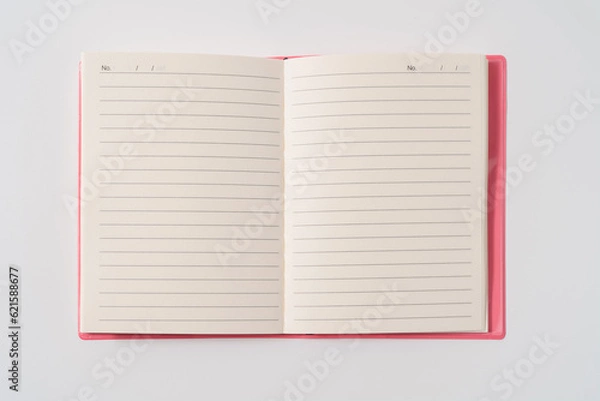 Obraz Pink notebook on white desk. Business minimal concept for women. Flat lay, top view, copy space