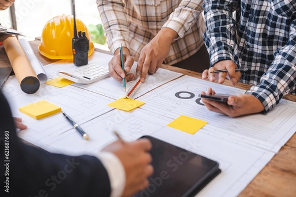 Fototapeta Factory Meeting Room of architect engineer meeting at working desk of blueprints construction concept. Engineer people concept