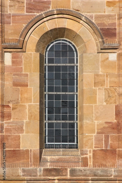 Fototapeta Romanesque round arch window at the Augustine monastery church in the old village of Pfaffen-Schwabenheim in Germany