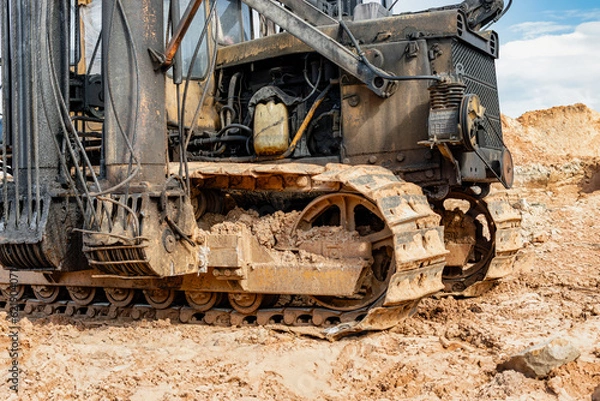 Fototapeta Pile driving machine. Diesel hammer pile driving machine working on construction site. Preparation of the pile foundation for the construction of the building. Close-up.