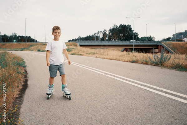 Obraz Smiling boy 7 years old rides on roller skates