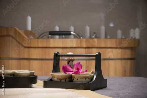 Fototapeta Natural treatments herbs treatment and candles in spa salon.