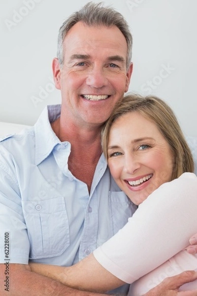 Fototapeta Portrait of a happy couple embracing at home