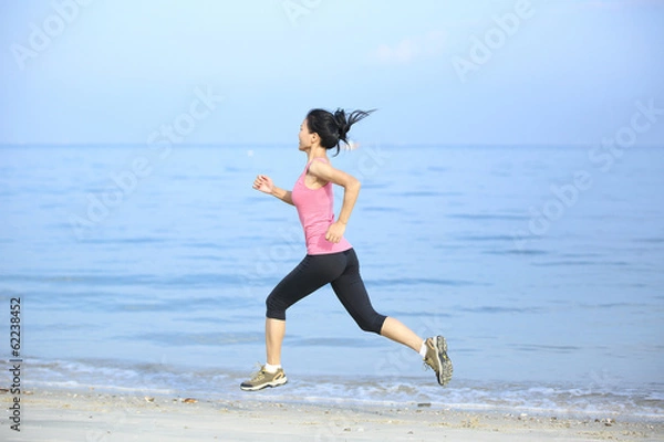 Obraz healthy lfiestyle woman running at beach