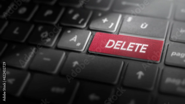 Fototapeta Delete key on laptop computer keyboard, red button on the dark grey keybord of a modern laptop notebook, technology concept for data deletion and removal, close-up