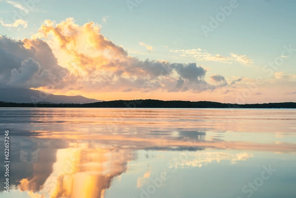 Fototapeta Seven seas beach with calm water reflecting the sky during the golden hour with clouds from fajardo, puerto rico.