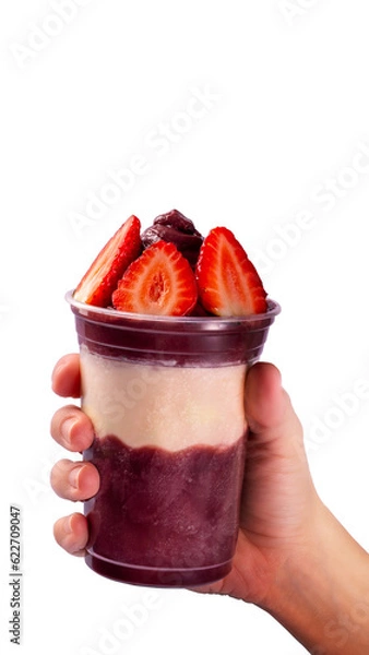 Fototapeta Hand holding a cup of açaí 