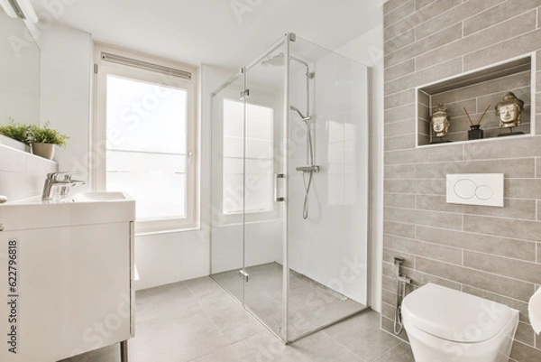 Obraz a bathroom with a toilet, sink and shower stall in the corners on the left side of the room