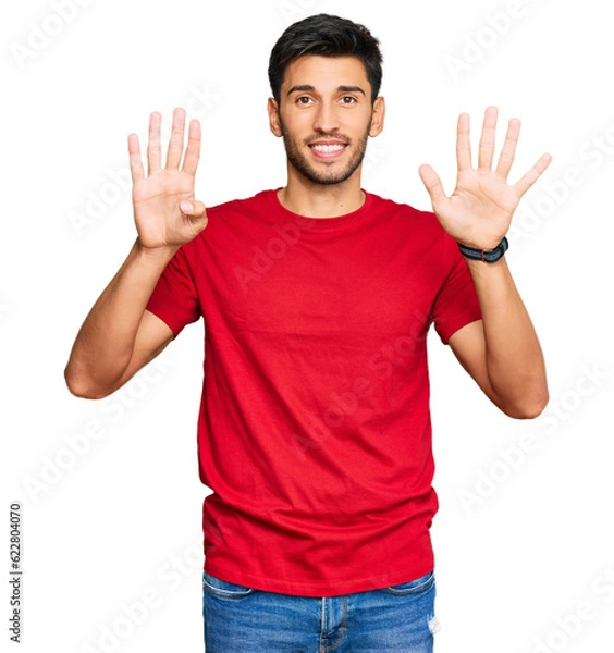 Fototapeta Young handsome man wearing casual red tshirt showing and pointing up with fingers number nine while smiling confident and happy.