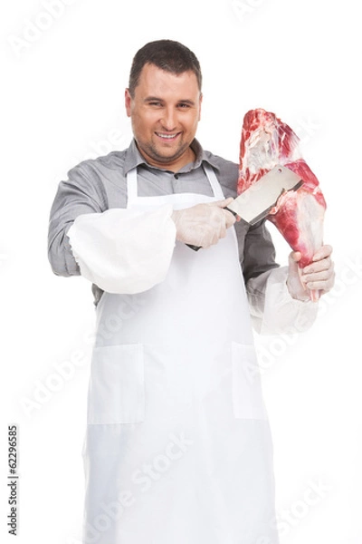 Obraz professional butcher cutting meat and smiling.