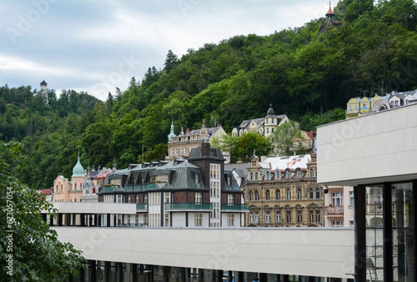 Fototapeta Beautiful buildings in traditional spa town of Karlovy Vary, Czech Republic. Traditional buildings of Karlovy Vary with the hills in the background.