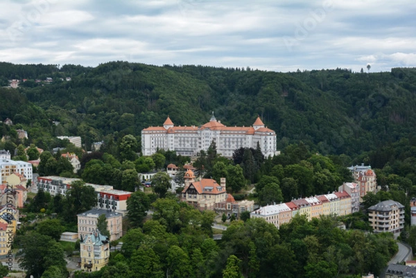 Fototapeta Beautiful colorful buildings in traditional spa town of Karlovy Vary, Czech Republic. Traditional buildings of Karlovy Vary, bird's eye panorama with the hills in the background.