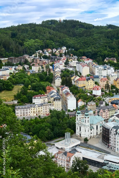 Fototapeta Beautiful colorful buildings in traditional spa town of Karlovy Vary, Czech Republic. Traditional buildings of Karlovy Vary, bird's eye panorama with the hills in the background.