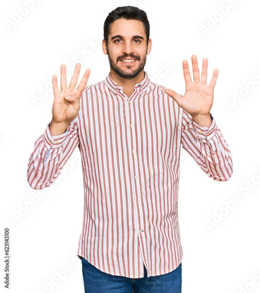Obraz Young hispanic man wearing business shirt showing and pointing up with fingers number nine while smiling confident and happy.