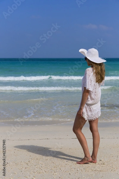 Obraz Woman standing on the beach enjoying summer holidays.