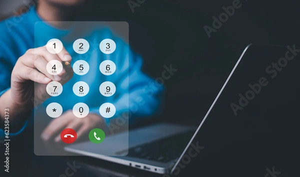 Fototapeta Dialing on virtual telephone keypad with transparent telephone buttons, businessman touch button of telephone number on screen, Finger touch number on smartphone to make a call, close up