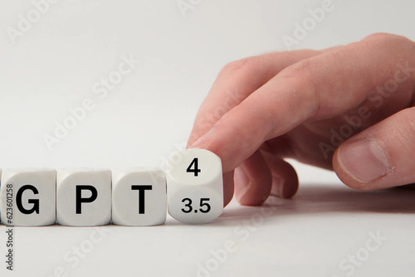 Fototapeta Hand turns dice and changes the expression "GPT 3.5" to "GPT 4" on white background 
