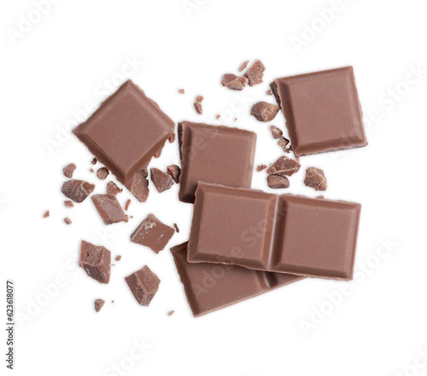 Fototapeta Pieces of delicious milk chocolate bar on white background, top view