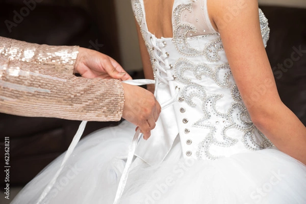 Fototapeta Corset being tied on a Quinceanera dress