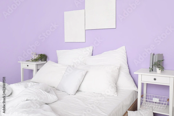 Fototapeta Comfortable bed with white pillows in interior of stylish bedroom