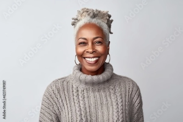 Obraz Medium shot portrait photography of a satisfied Nigerian black woman in her 50s wearing a cozy sweater against a white background 