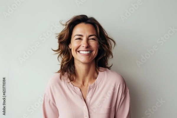 Obraz Portrait of a happy young woman smiling and looking at camera.