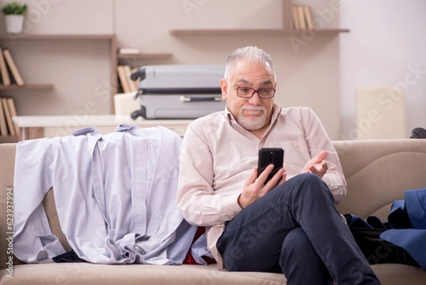 Obraz Old man preparing for trip at home