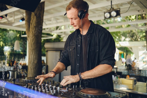 Fototapeta DJ at work on the summer playground.