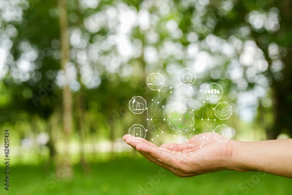 Fototapeta Technology, hand holding with environment Icons over the Network connection on green background.