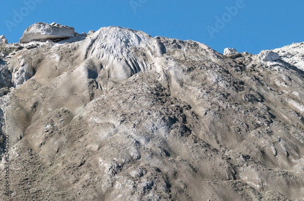Fototapeta The limestone hillside on the background of blue sky