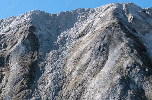 Fototapeta The limestone hillside on the background of blue sky