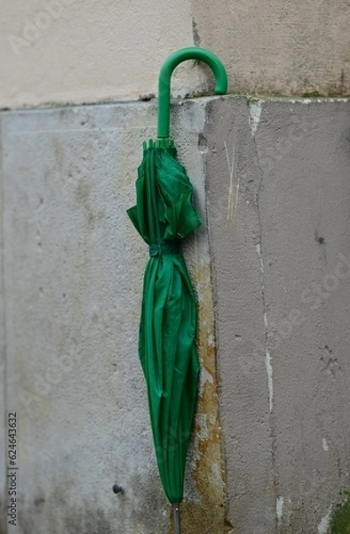 Obraz Green umbrella on the corner of a house