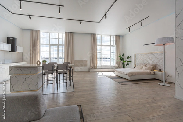 Fototapeta minimalistic modern luxury design of an expensive house with marble trim on a sunny day. white walls with plaster, parquet, decorative lighting and no one inside