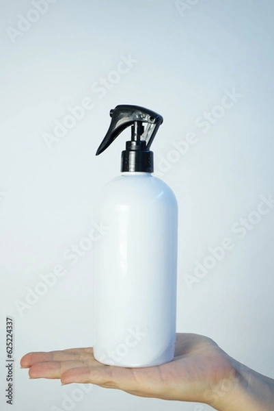 Fototapeta hand with spray bottle