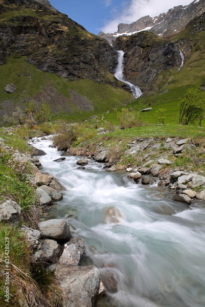 Fototapeta The mountain stream and waterfall Py, located above the hamlet Laisonnay d'en Haut in the valley of Champagny le Haut, Vanoise National Park, Northern French Alps, Tarentaise, Savoie, France