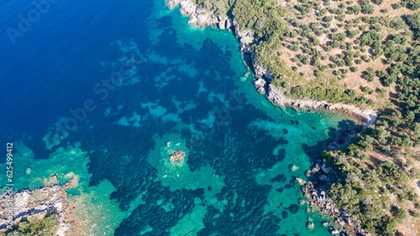 Fototapeta Aerial view of sea waves and fantastic Rocky coast, Greece. Top view of coastal rocks in Ionian Sea. Landscape view point of Ionian Sea  in the morning.
