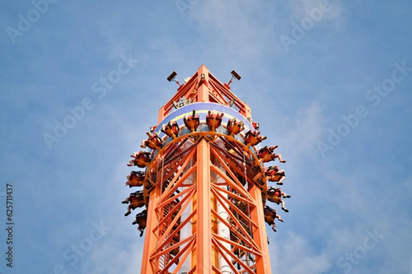 Obraz People free falling from tower ride at amusement park. Free Fall Tower in the amusement park.