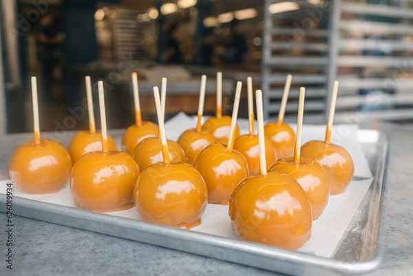 Fototapeta Candied apples on a tray in the window of a bakery.