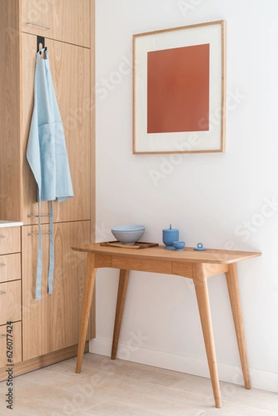 Fototapeta dishware on wood desk, apron hanging on hook and decor on wall