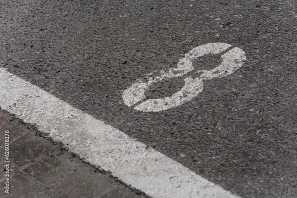 Fototapeta a number 8 painted on asphalt parking spot