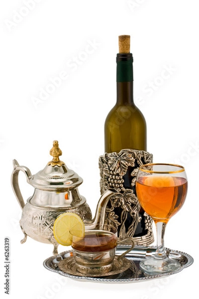 Fototapeta Tea with a lemon and wine in ancient silver utensils