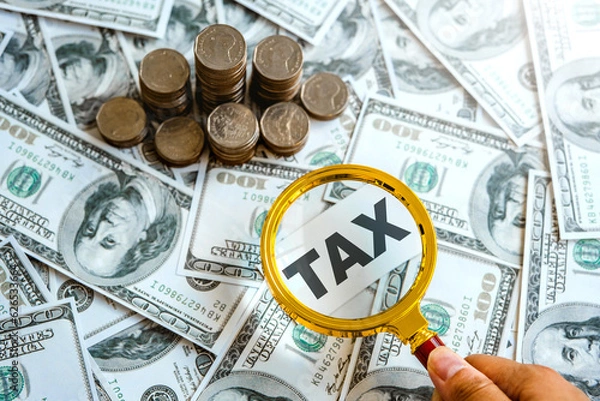 Fototapeta Hand with magnifier  search for income tax return form online for tax payment. Government, state taxes. Data analysis, paperwork, financial research
