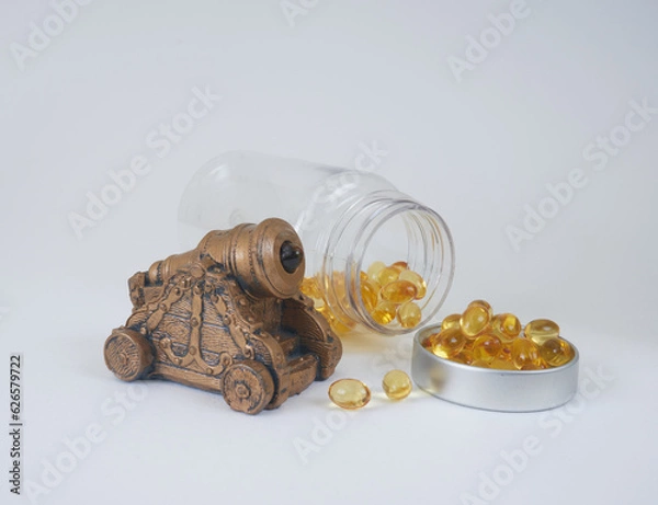 Fototapeta cannon and vitamins in capsules with bottle