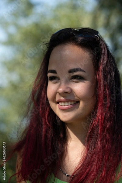 Obraz Close-up portrait of a girl in a city park in summer